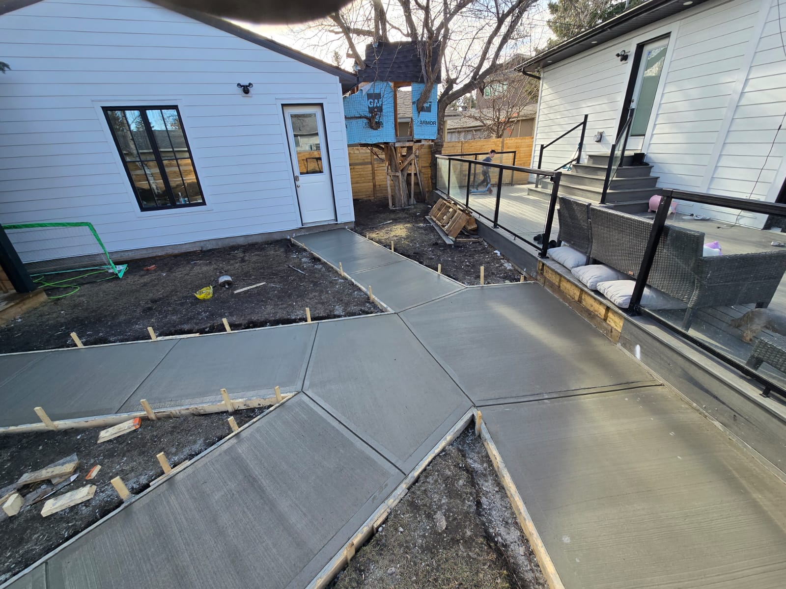 Backyard concrete patio layout with tooled joints