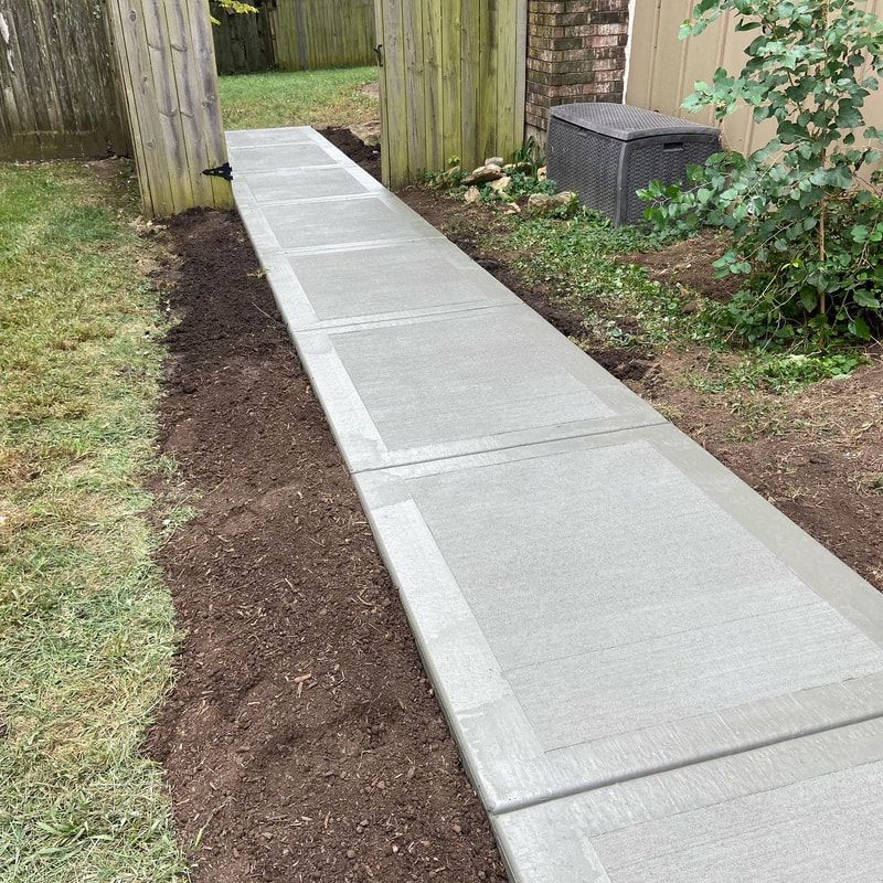 Concrete pathway through backyard