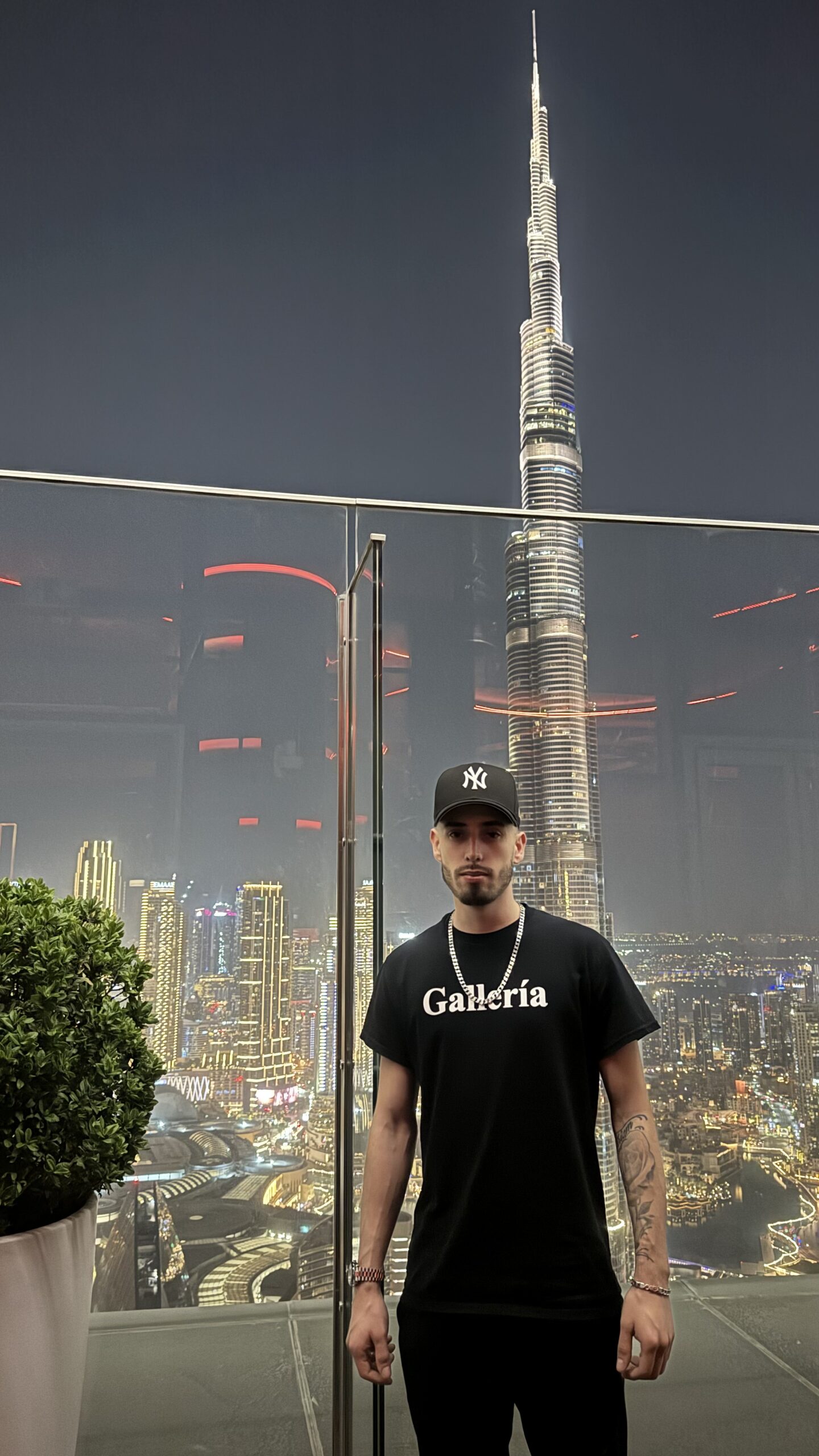 Cody Wise on the CÉ LA VI rooftop at Address Sky View in Downtown Dubai, the Burj Khalifa lit behind him.
