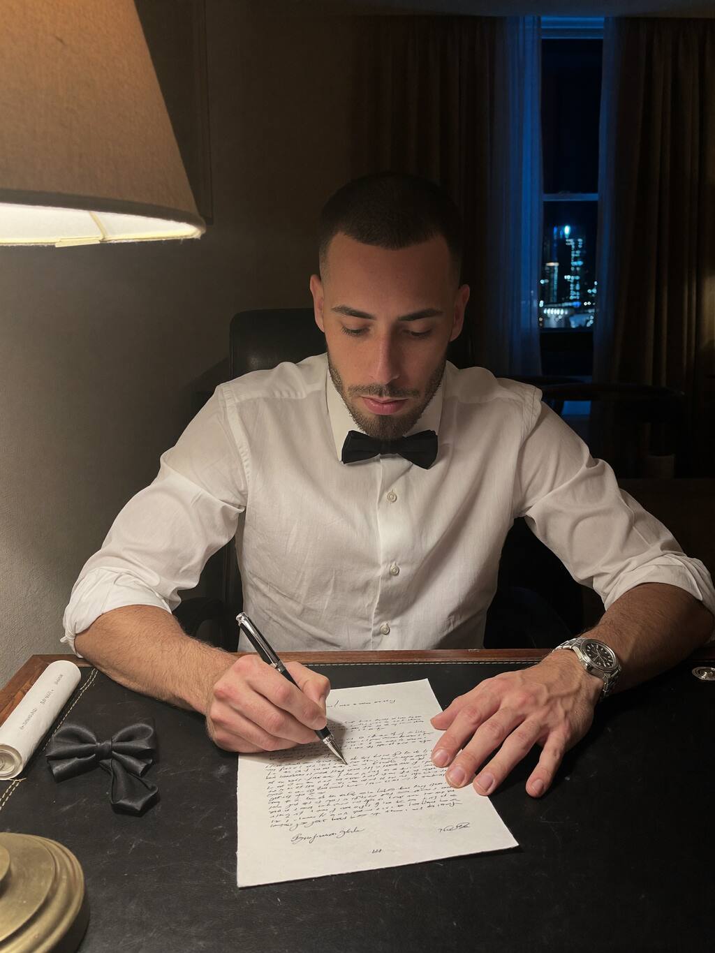 Cody Wise writing at a desk at night