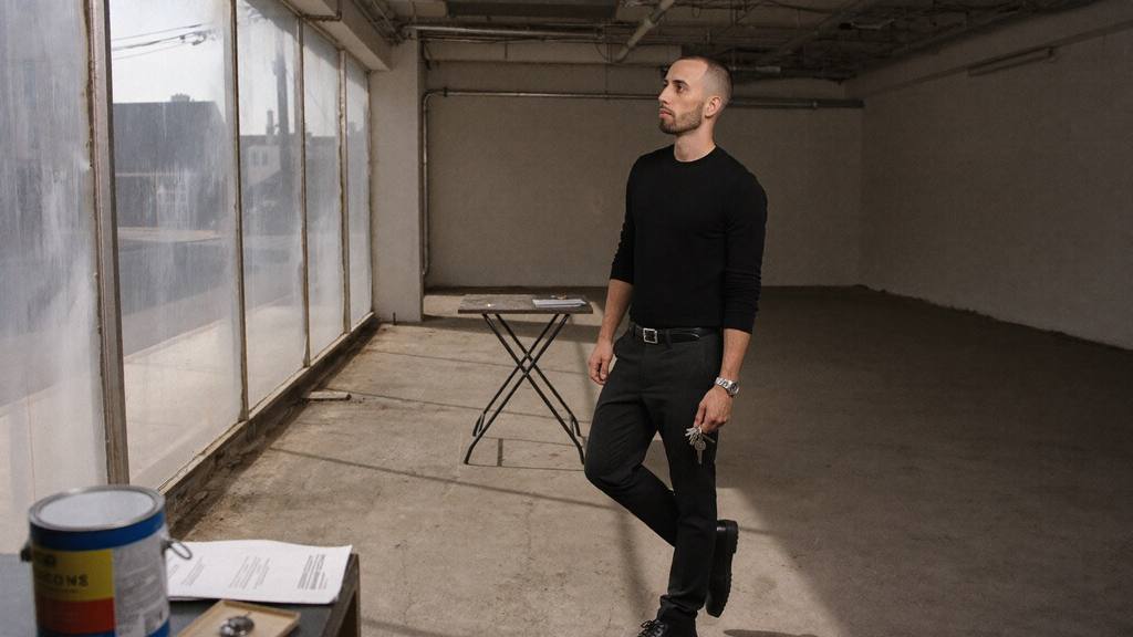 Cody Wise holding keys in an empty commercial unit during a handover