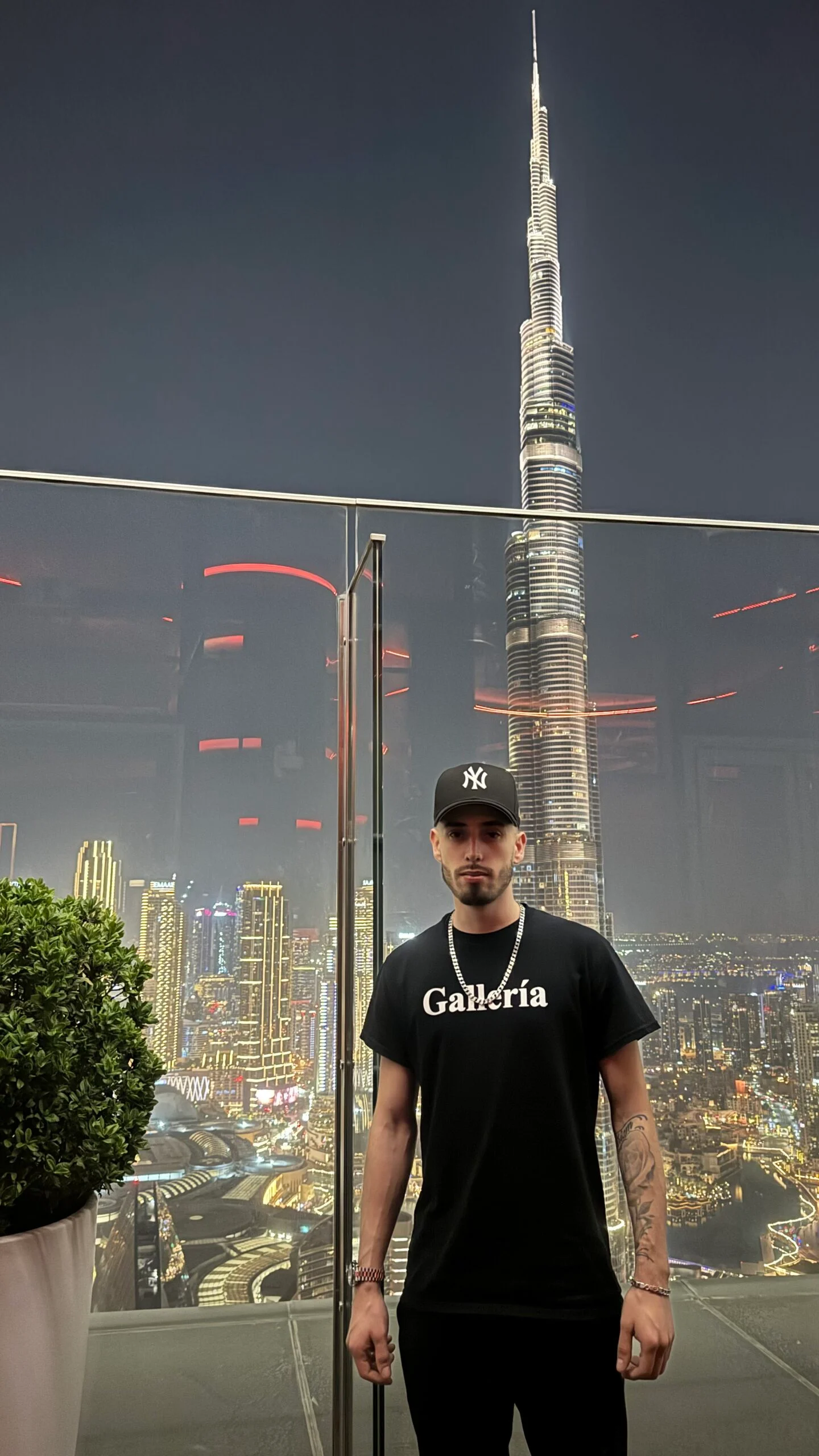 Cody Wise on the CÉ LA VI rooftop at Address Sky View in Downtown Dubai, the Burj Khalifa lit behind him.