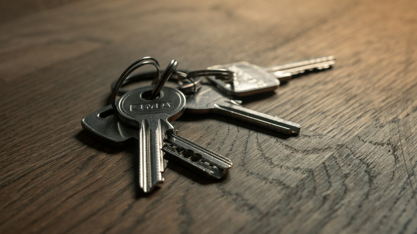 House keys on a wooden table, the simple outcome an asset-backed product should sell before its technology