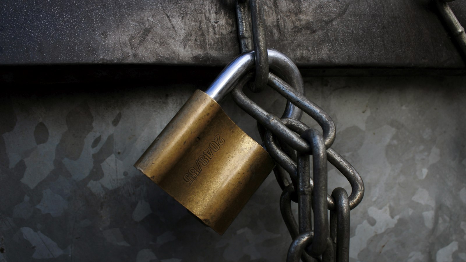 Brass padlock on a heavy chain: every want that sits in another person's hand becomes a leash