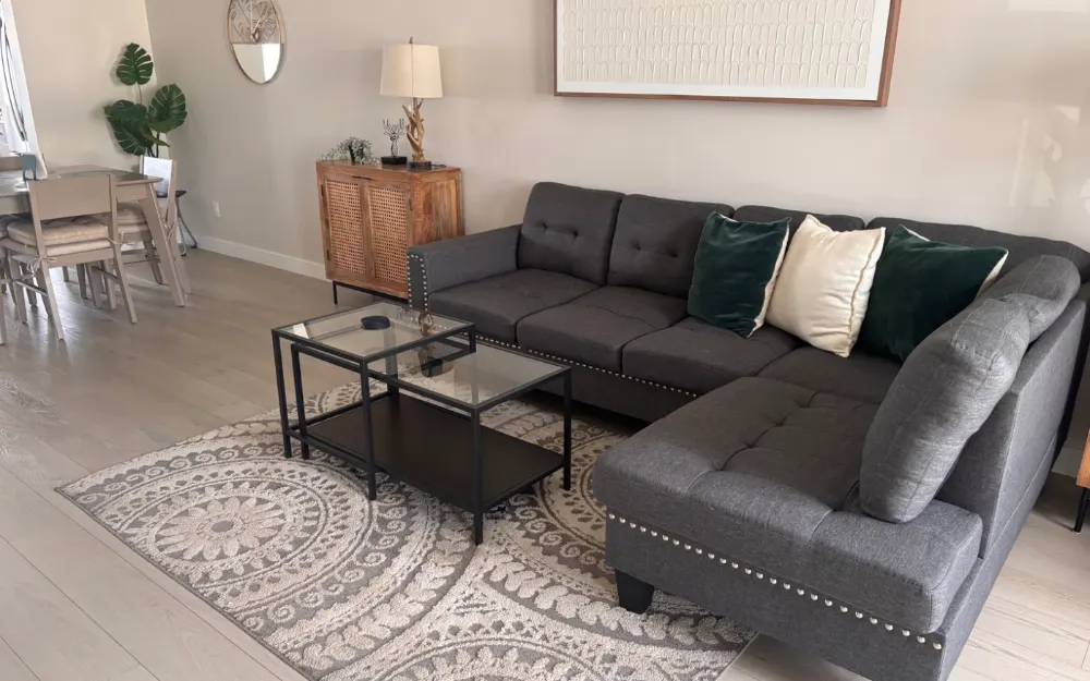 Living room reset after a CleanStays turnover, cushions squared and floors done