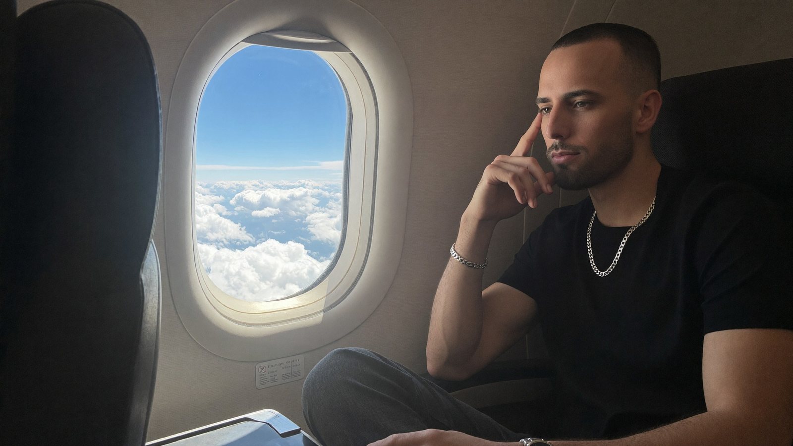Cody Wise at an airplane window above the clouds, the test of a business built to run while its founder is unreachable