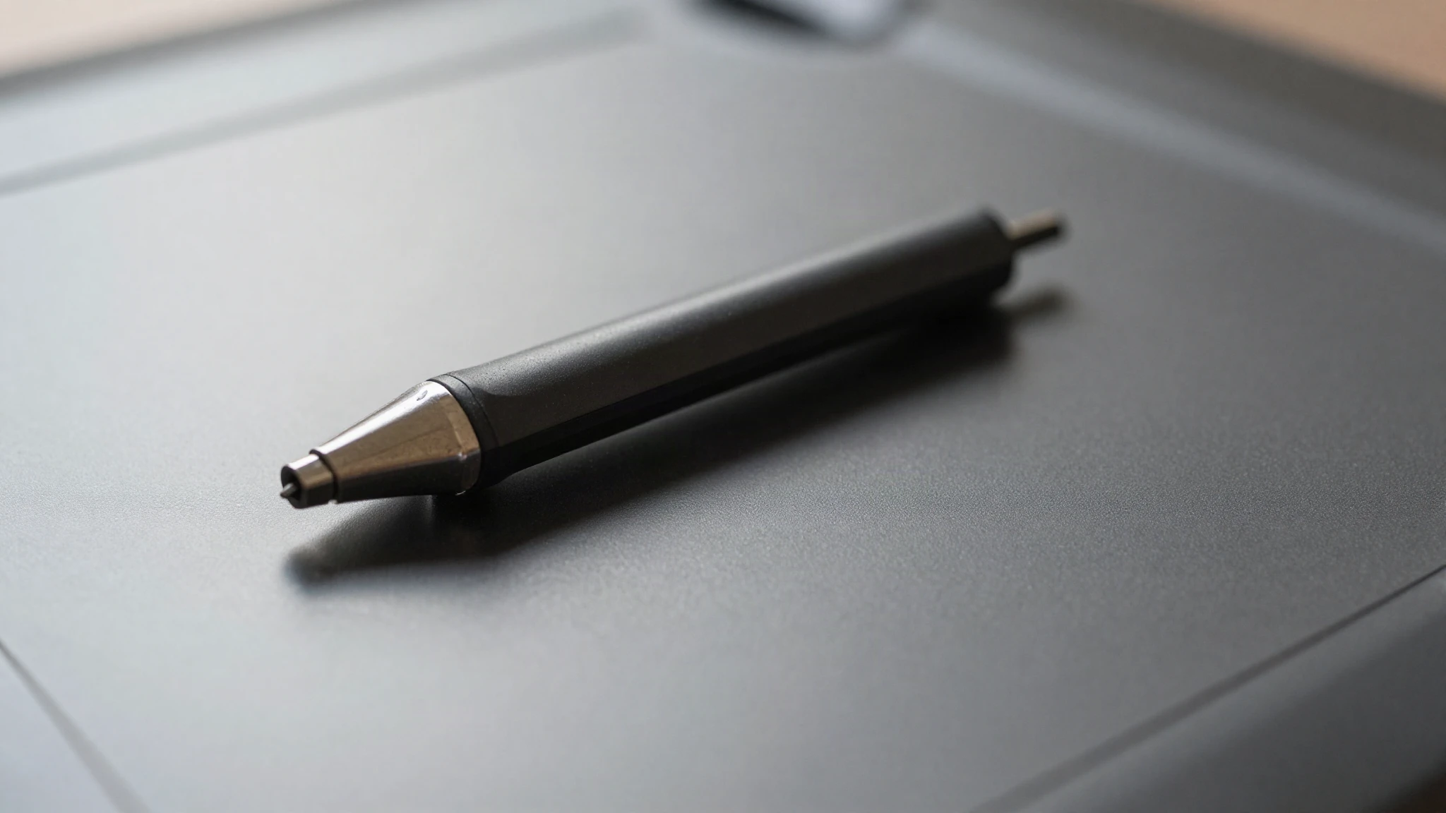 Macro of a stylus resting on the textured surface of a graphics tablet
