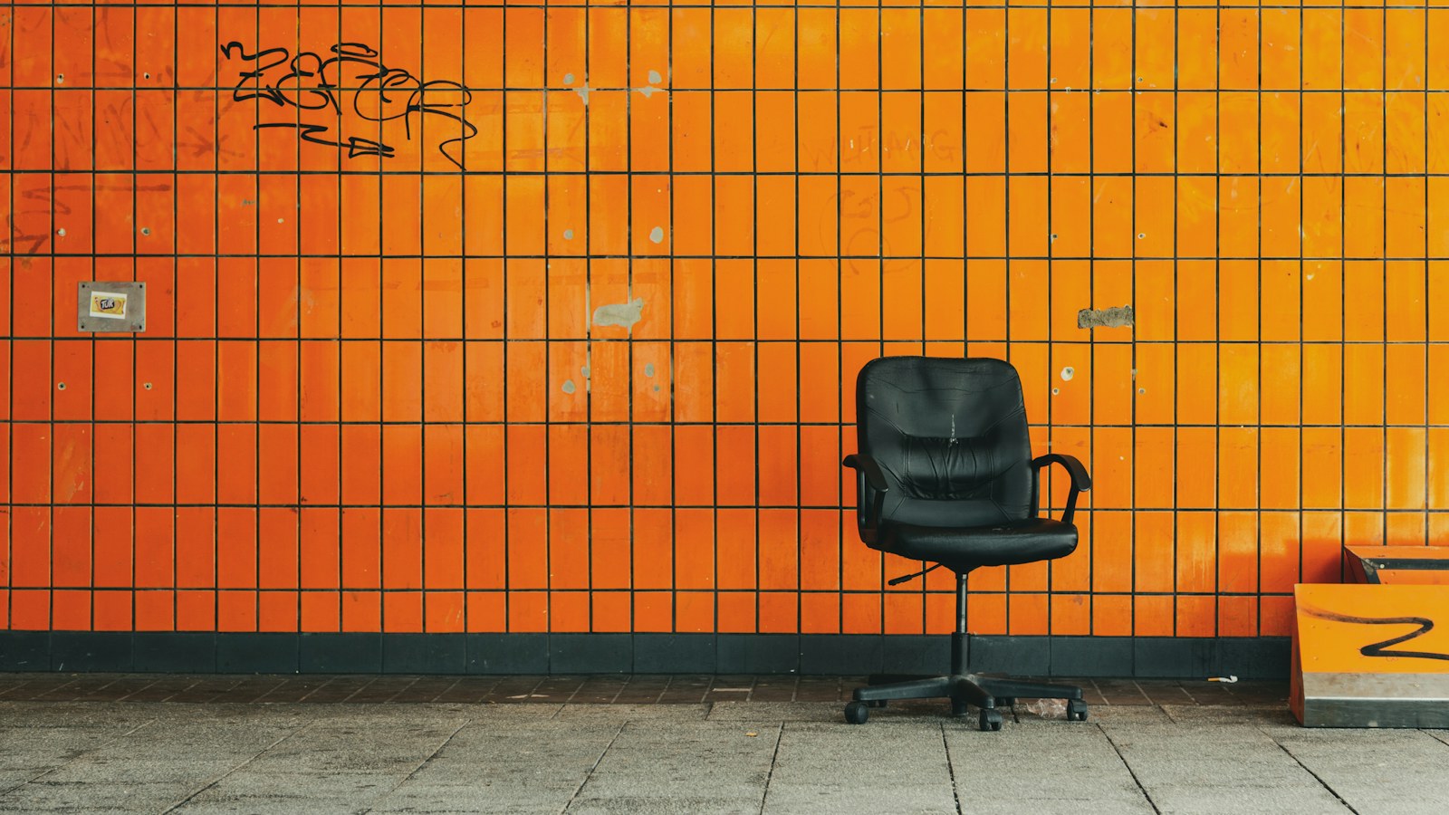 An empty office chair against a wall, the seat every decision still routes through when a founder has no succession plan