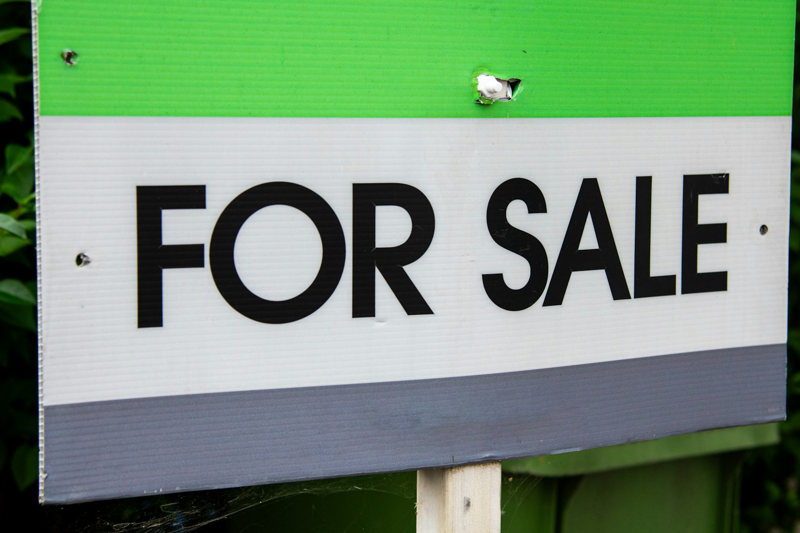 For sale sign on a property, a reminder that real estate earns every night but can take months to sell