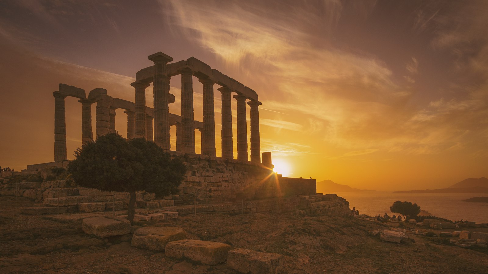 Ancient Greek temple ruins on the coast at sunset, the kind of shoreline where an exiled Epictetus rebuilt his school