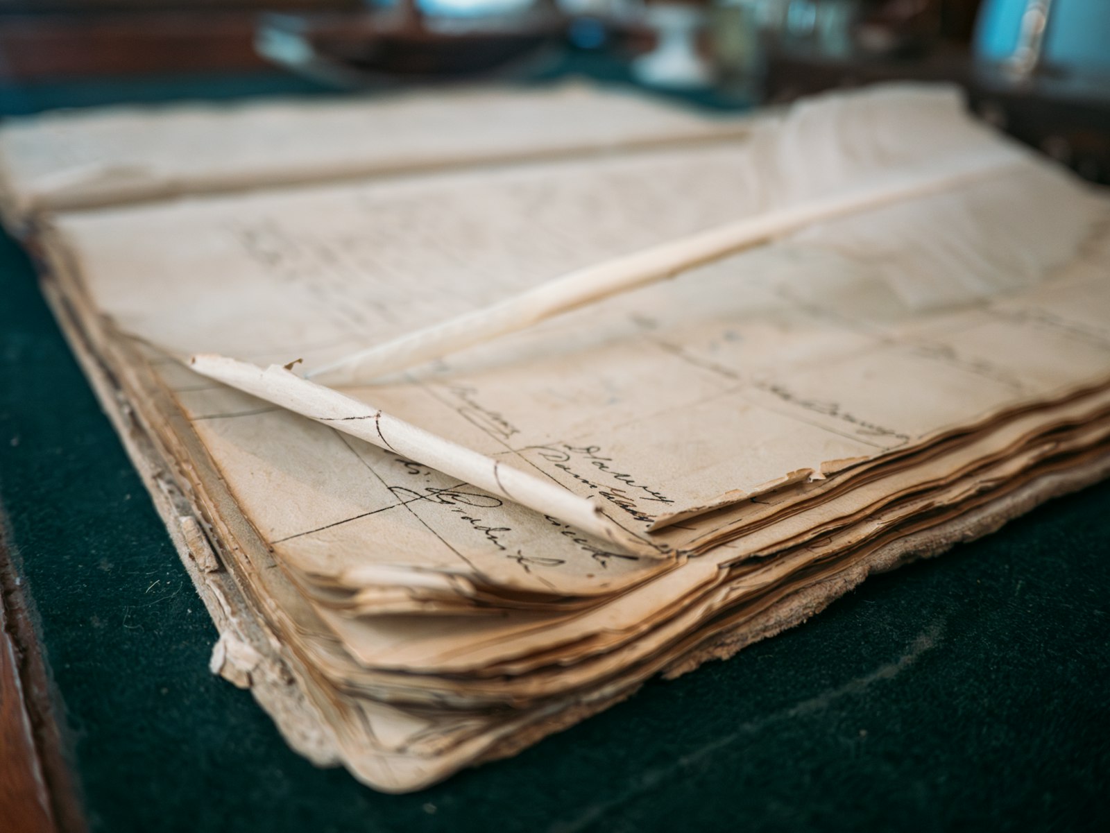 Old handwritten ledger and quill, the original ownership record that on-chain tokenization modernizes
