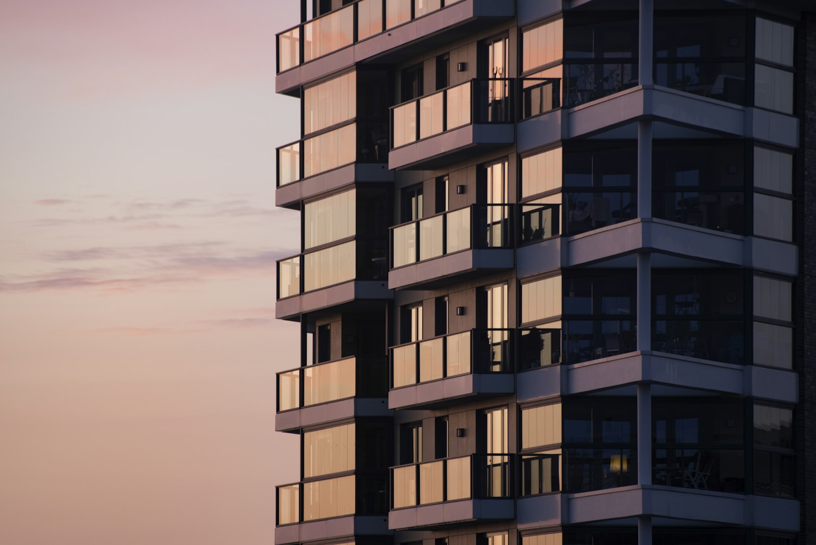 Modern apartment building at dusk, the real-world asset a tokenization brand should lead with before the token
