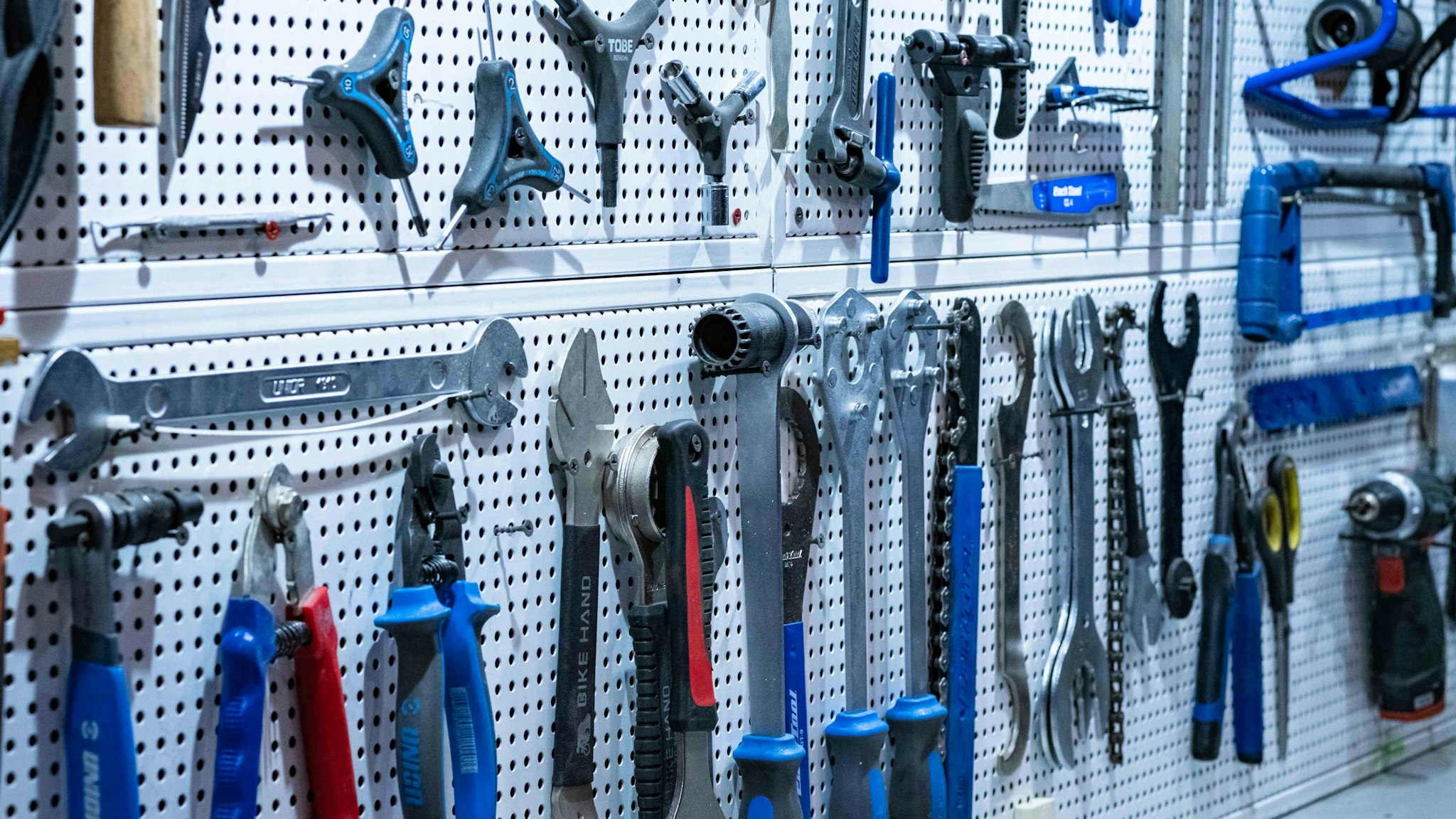 Hand tools hung in order on a workshop wall