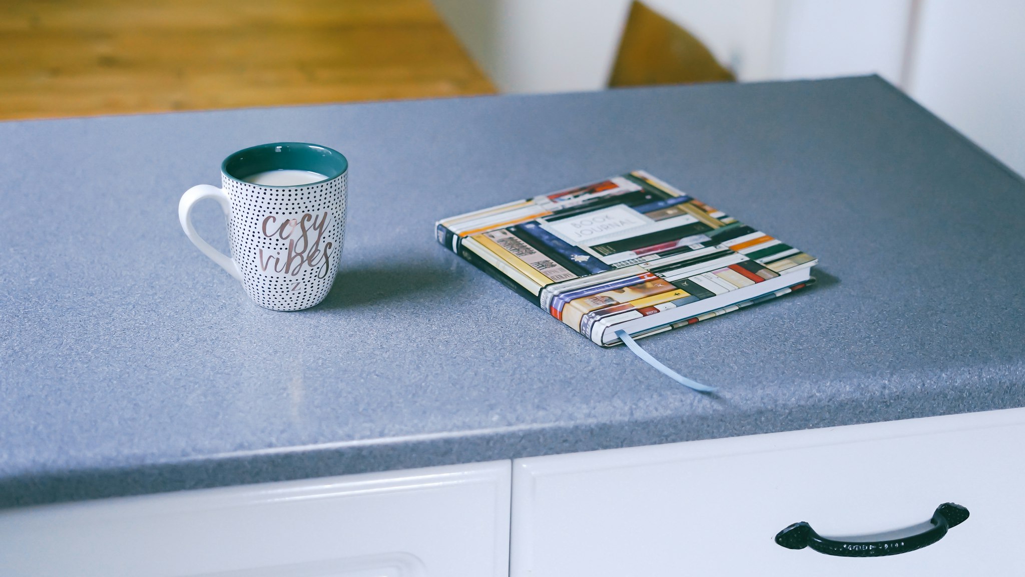 Open notebook and pen on a counter with handwritten notes