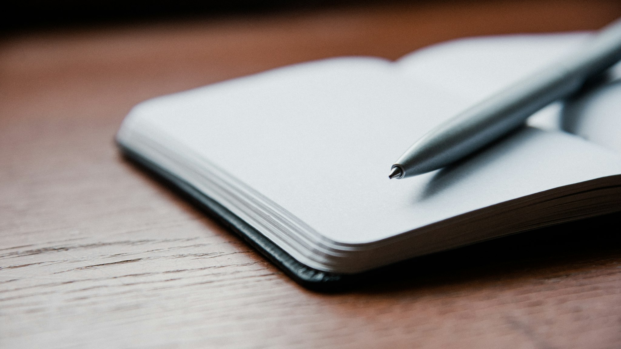 A pen resting on an open notebook, ready to write down the purpose, the conditions and the funding engine